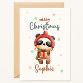 Christmas card with a panda wearing a hat and scarf, holding a gift, with 'Merry Christmas Sophie' text.